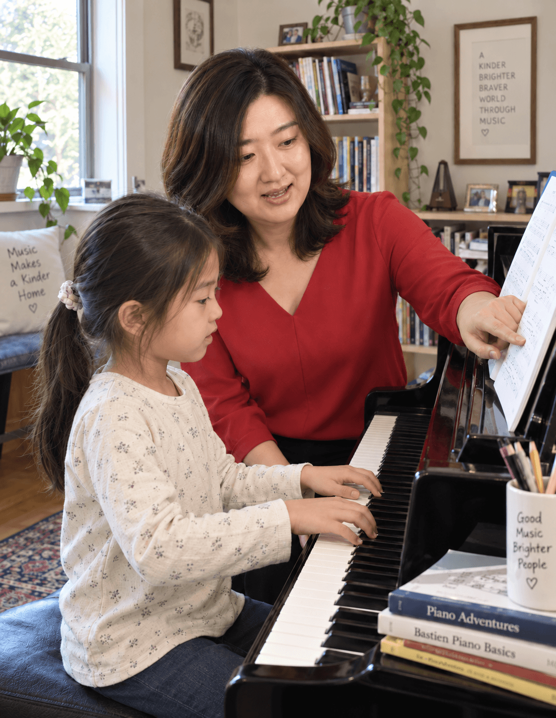 Dami Jeong guiding a student at the piano
