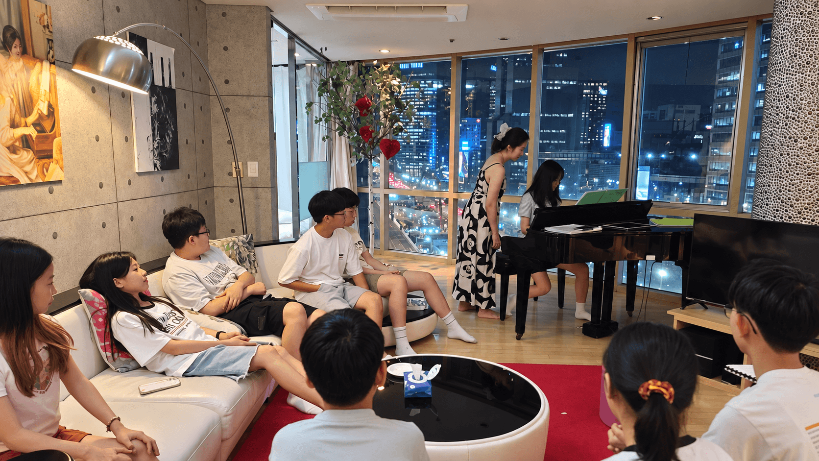 Students gathered for a studio piano performance